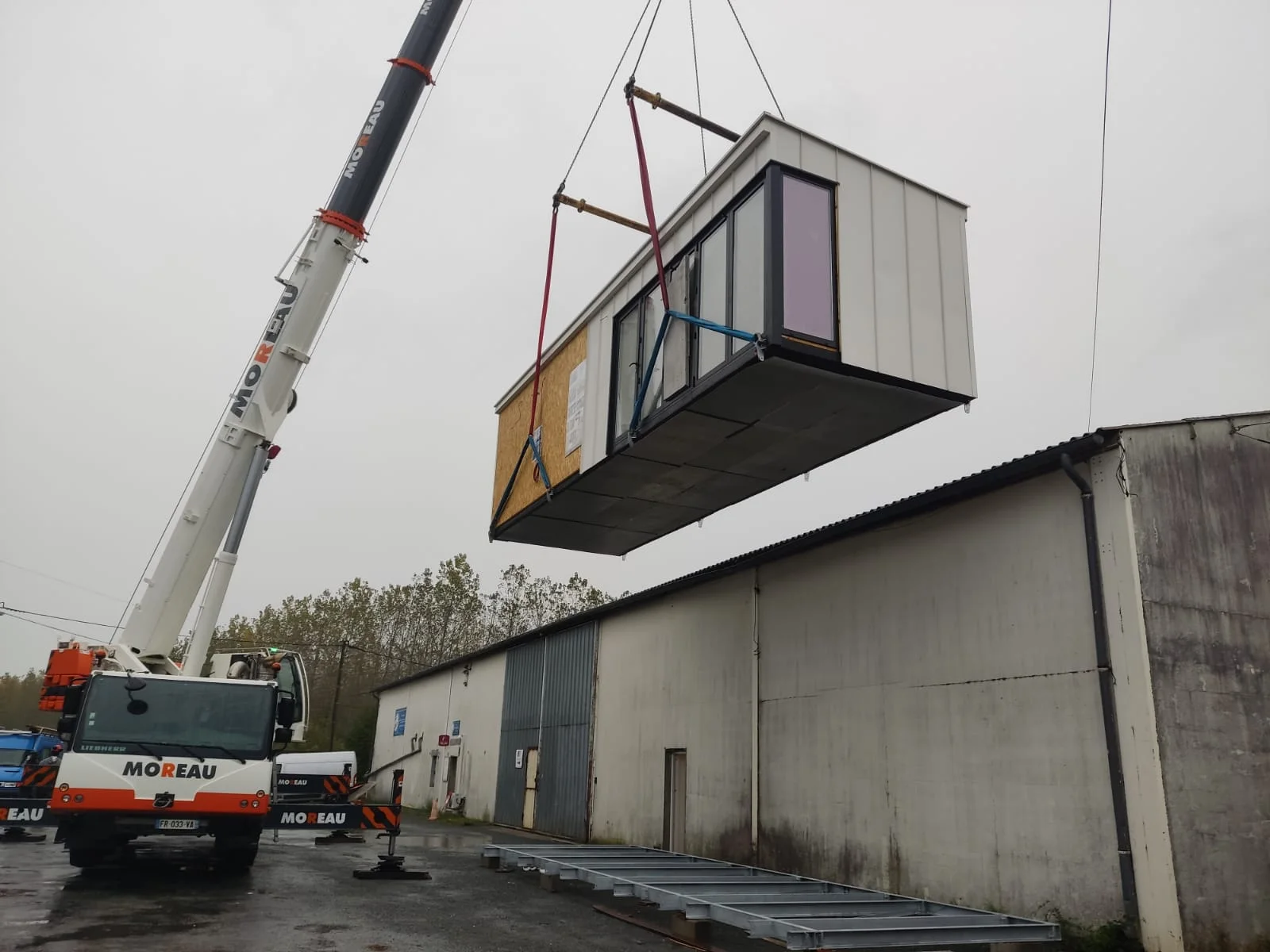 Prefabricated module lifted by crane — 1